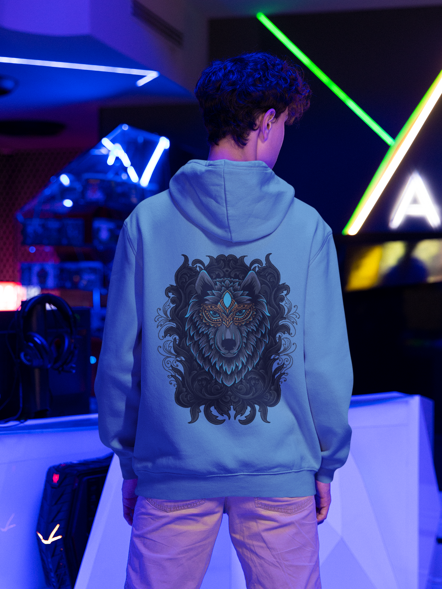 A men wearing a blue mist color fashionable hoodie showcasing the elegance and might of Wepwawet, the ancient Egyptian God.