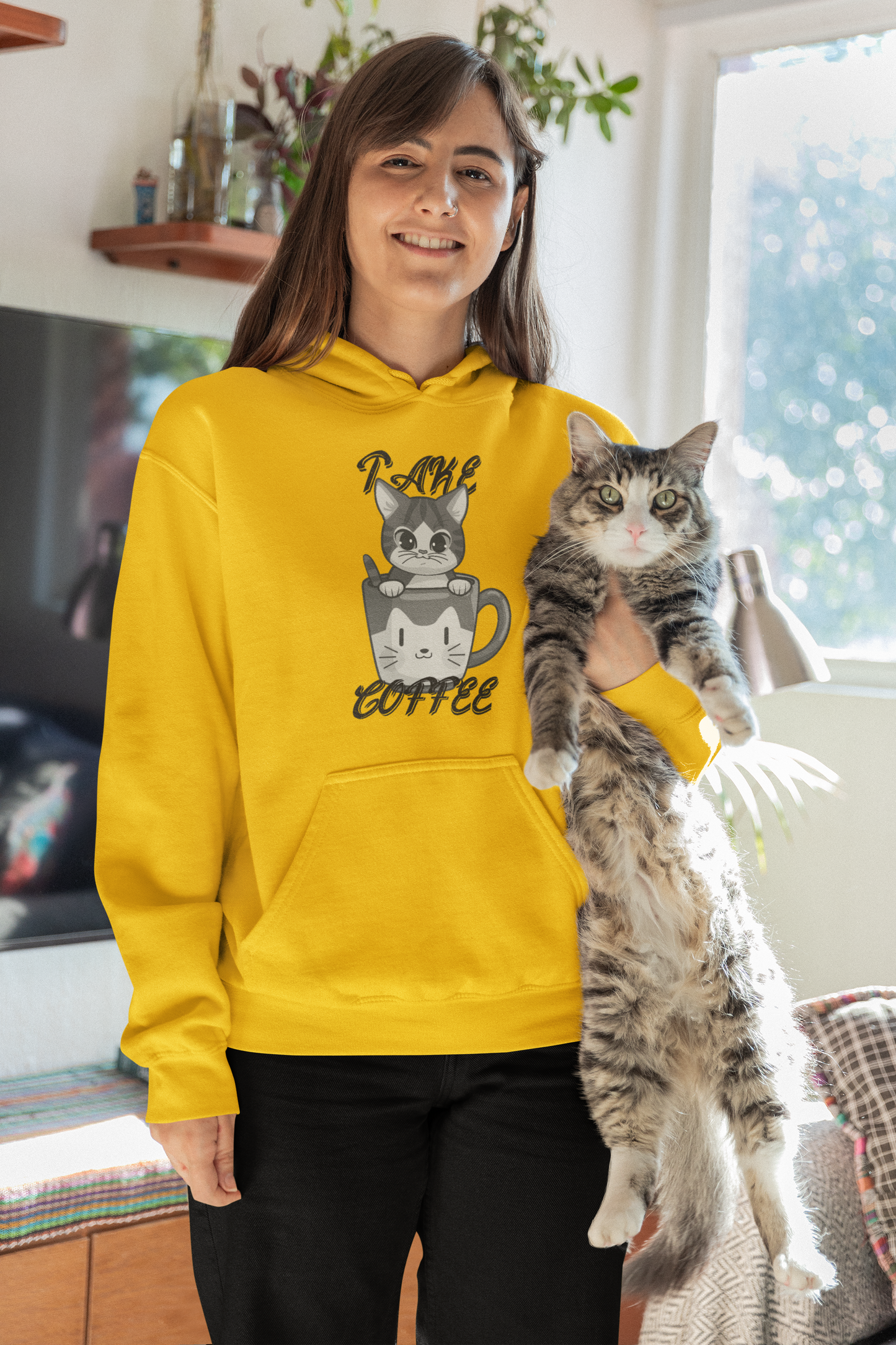 Happy girl wearing cat lover mustard hoodie with holding a cat.