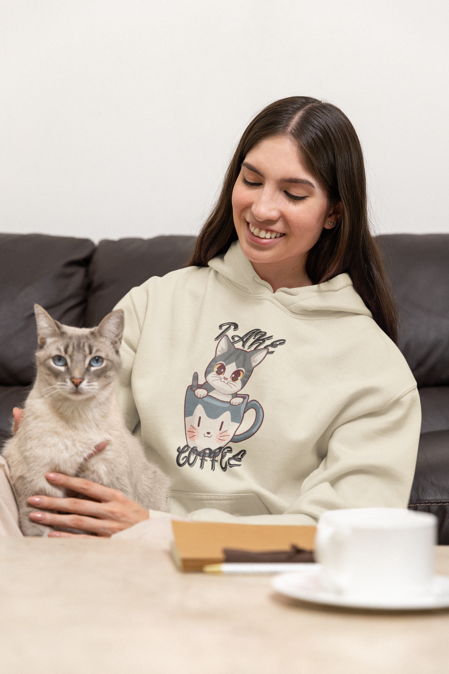 Cute cat is sitting with lady wearing a cute cat printed hoodie