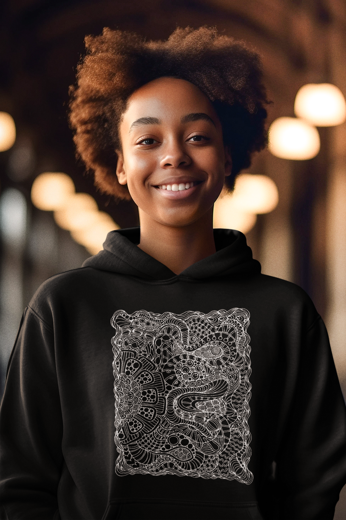 A women wearing a black hoodie featuring a cutting-edge abstract pattern in white for a fashionable look.