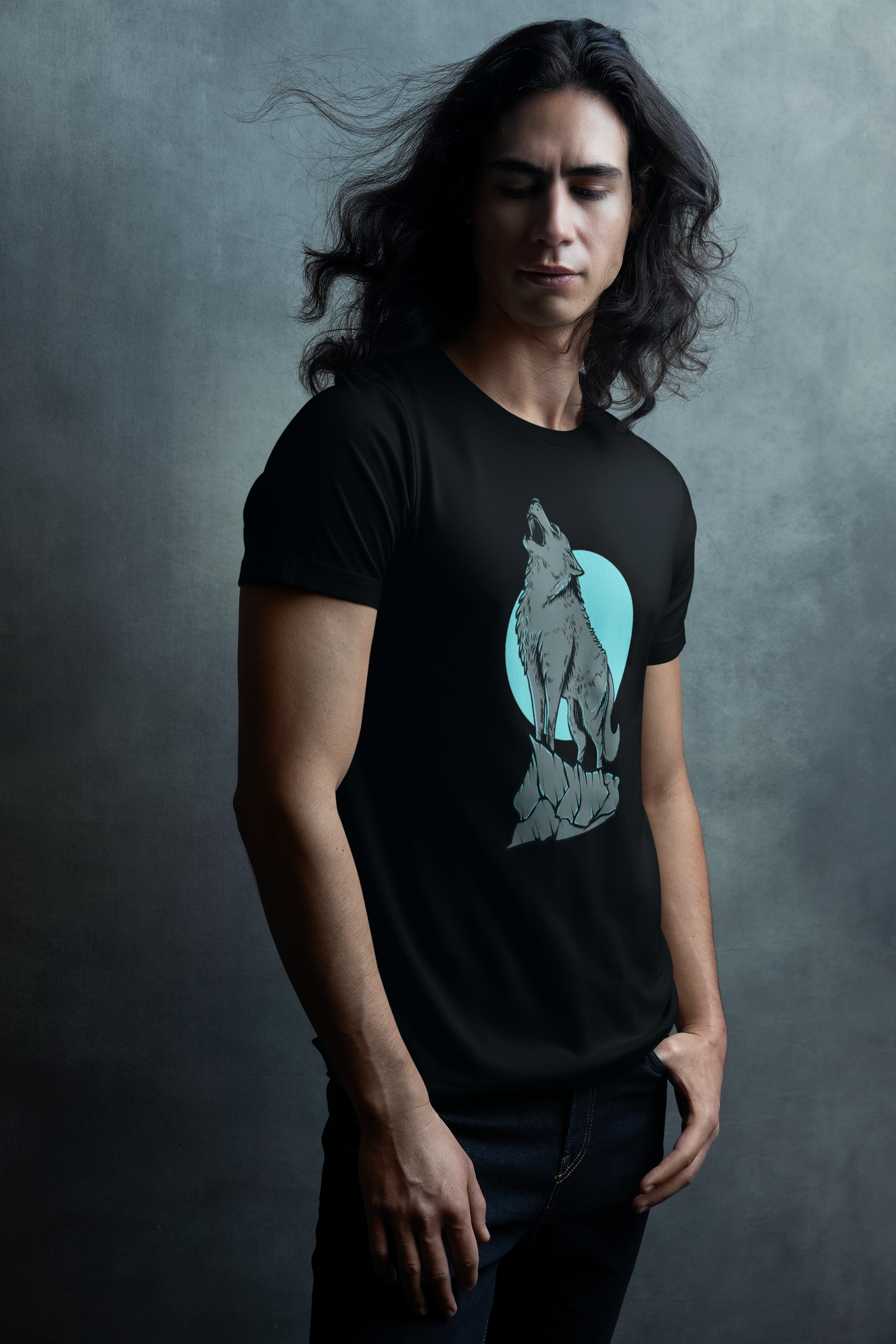 A men wearing black t-shirt with serene and enchanting scene of a wolf in the moonlight, with the full moon illuminating the wilderness.