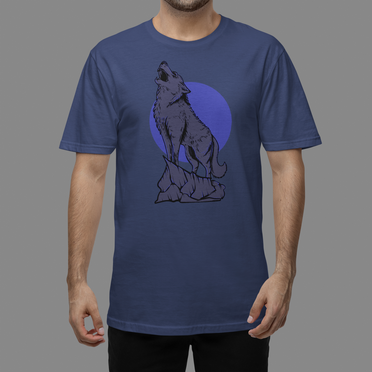 A navy blue t-shirt with serene and enchanting scene of a wolf in the moonlight, with the full moon illuminating the wilderness.