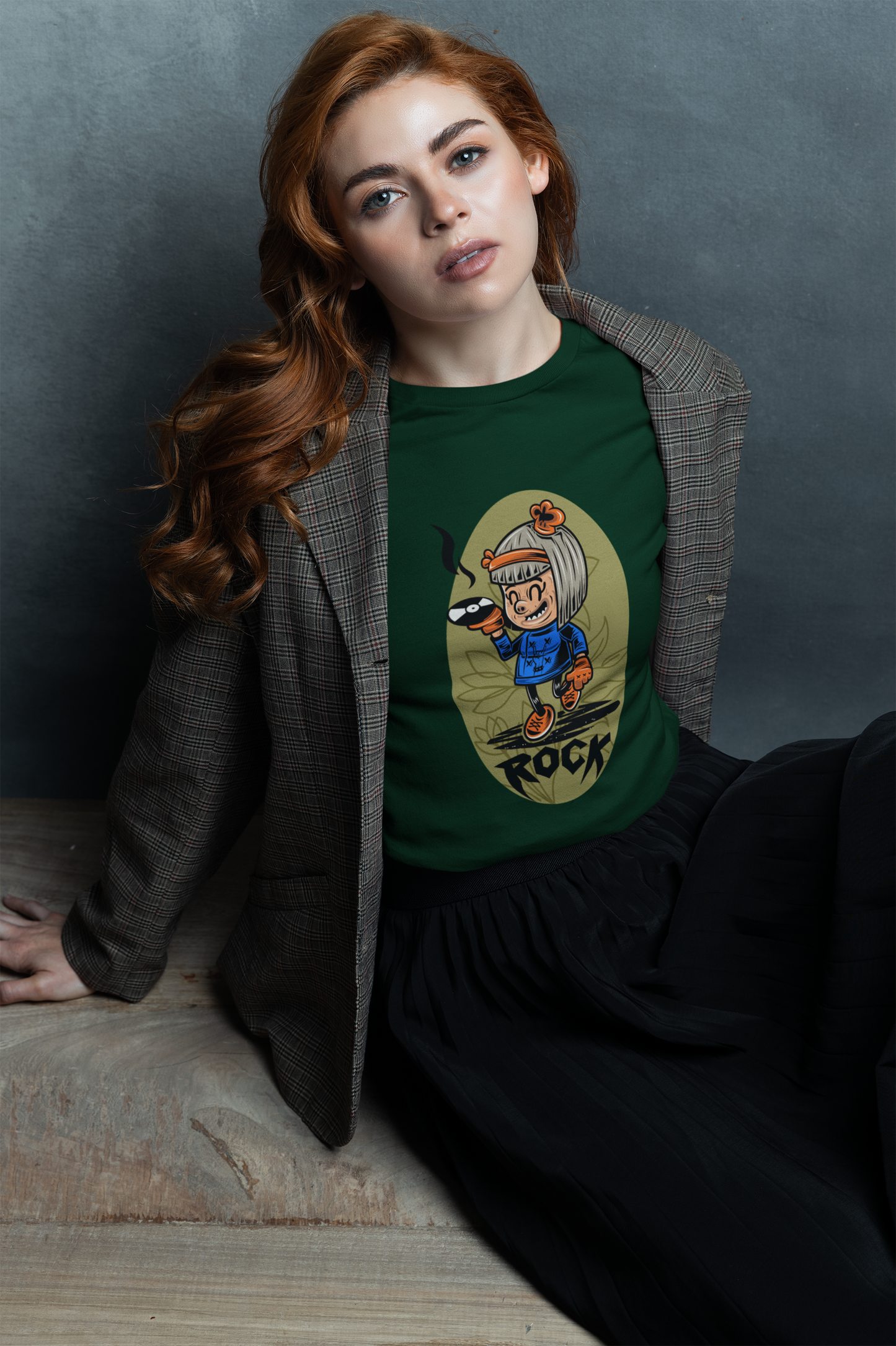 A women wearing a stylish t-shirt featuring a girl with a rock 'n' roll attitude and bold, edgy wording.
