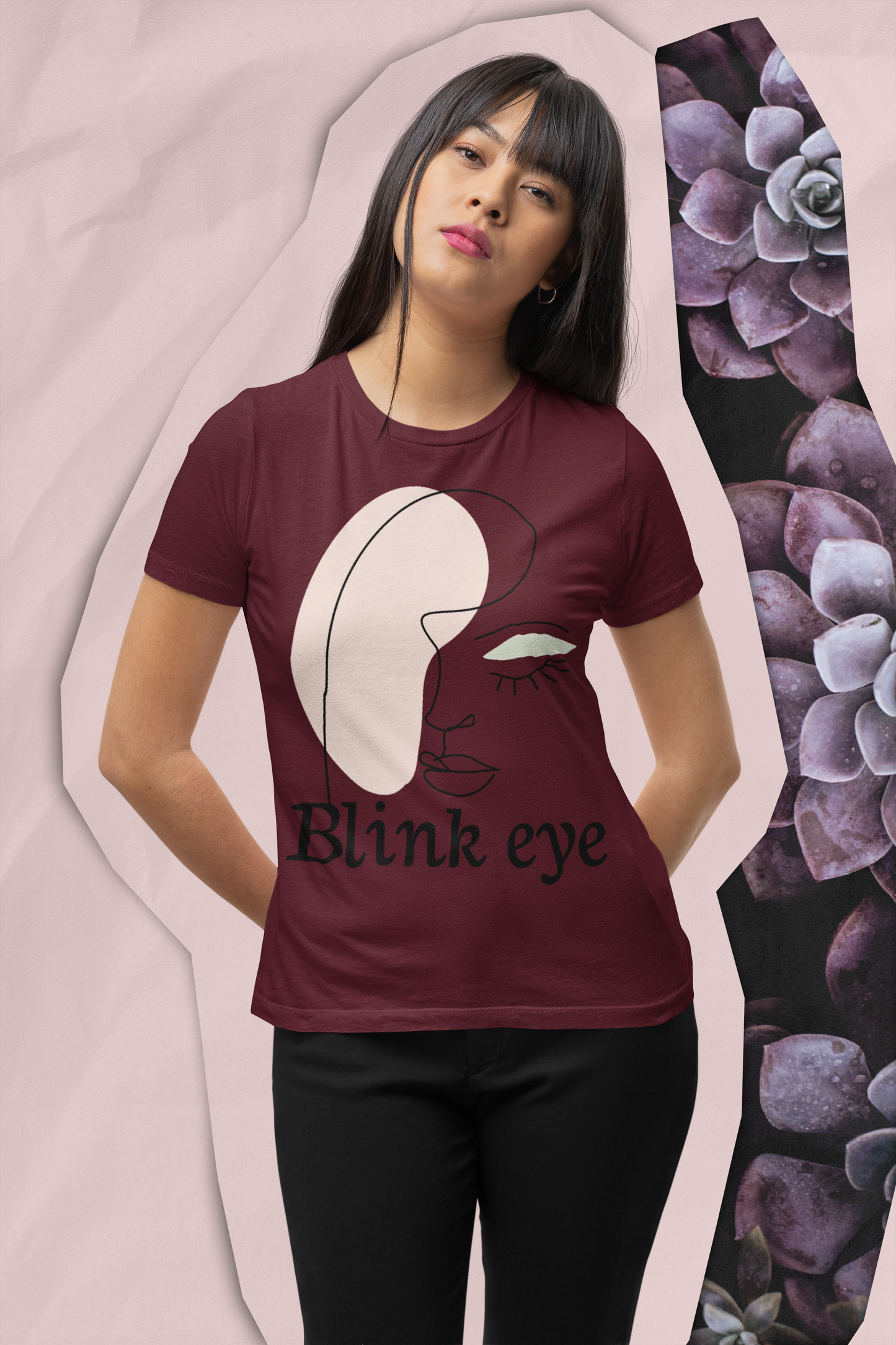A girl is wearing maroon blinked eye graphic crew neck t-shirt with black bottom