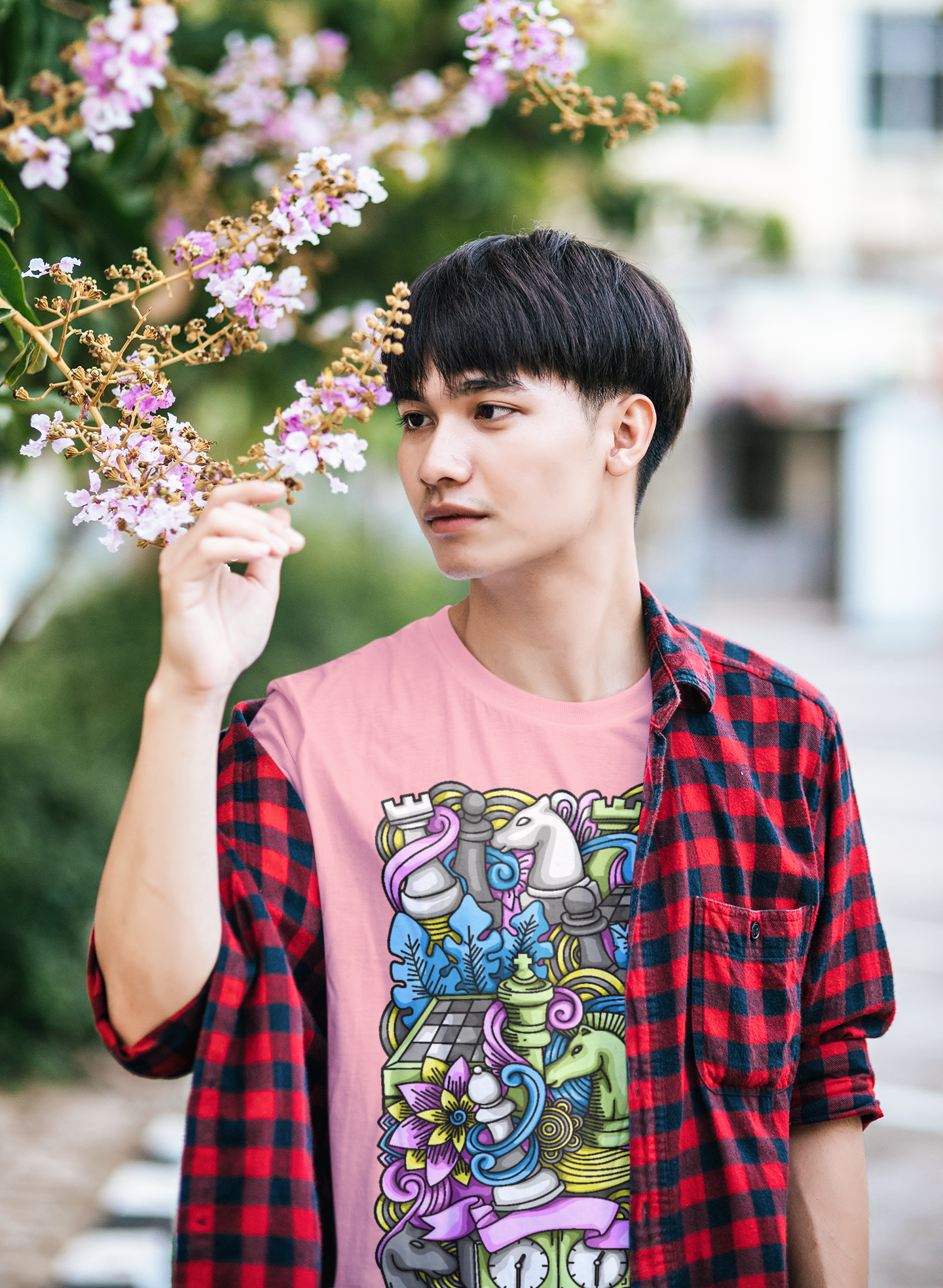 A boy wearing a tee that humorously celebrates the intricacies of chess with 'The Chess Mess' design.