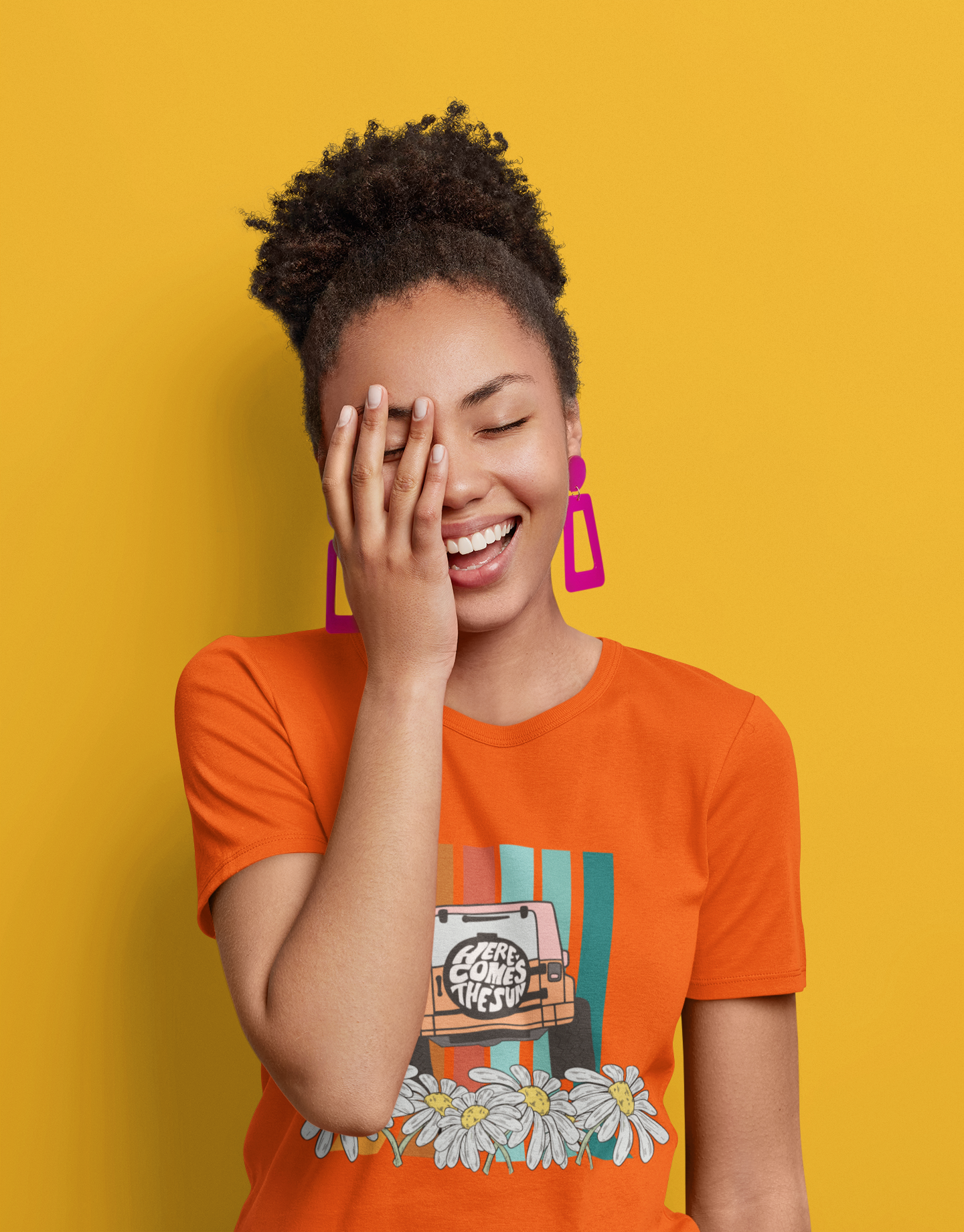 A orange t-shirt with a vibrant, retro-style floral pattern in shades of red, mustard, and green