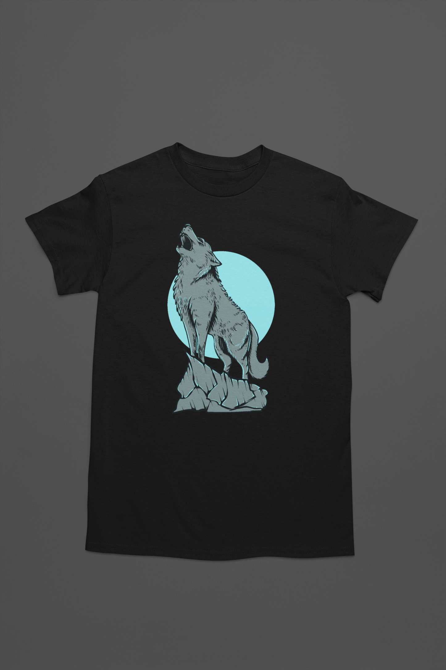 A black t-shirt with serene and enchanting scene of a wolf in the moonlight, with the full moon illuminating the wilderness.