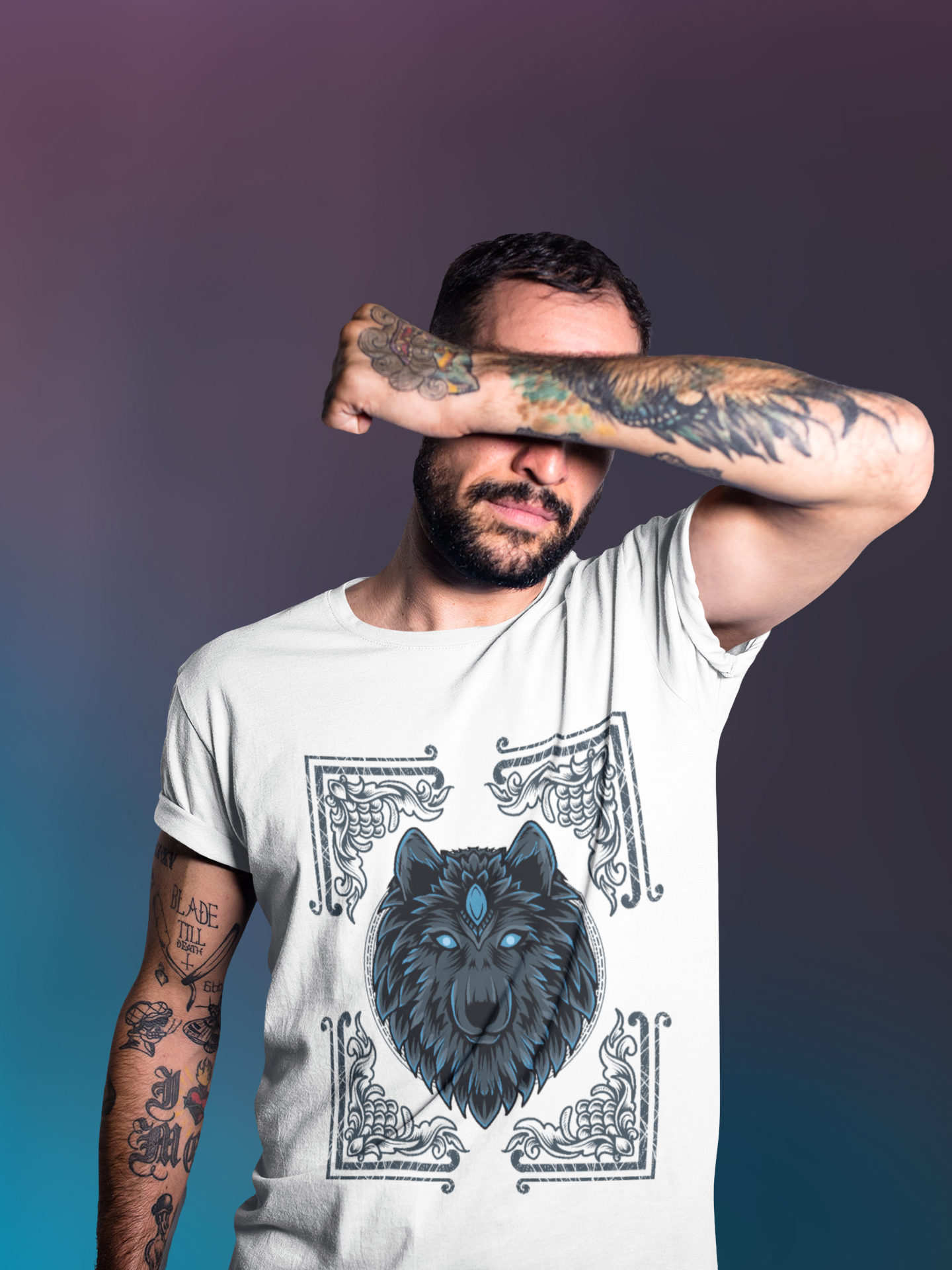 A men is hiding his eyes and wearing white t-shirt with  regal wolf adorned with Egyptian motifs, framed within a decorative card design.