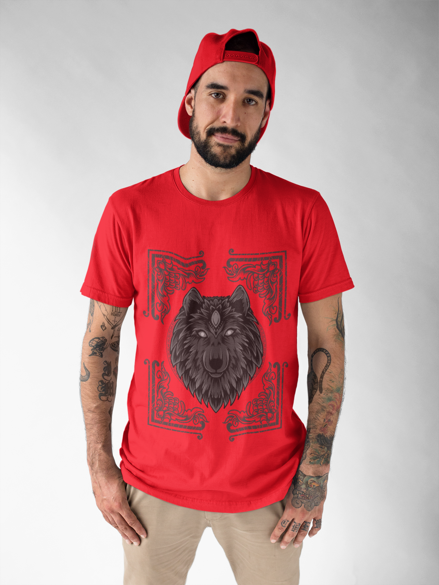 A men wearing a red t-shirt with regal wolf adorned with Egyptian motifs, framed within a decorative card design.