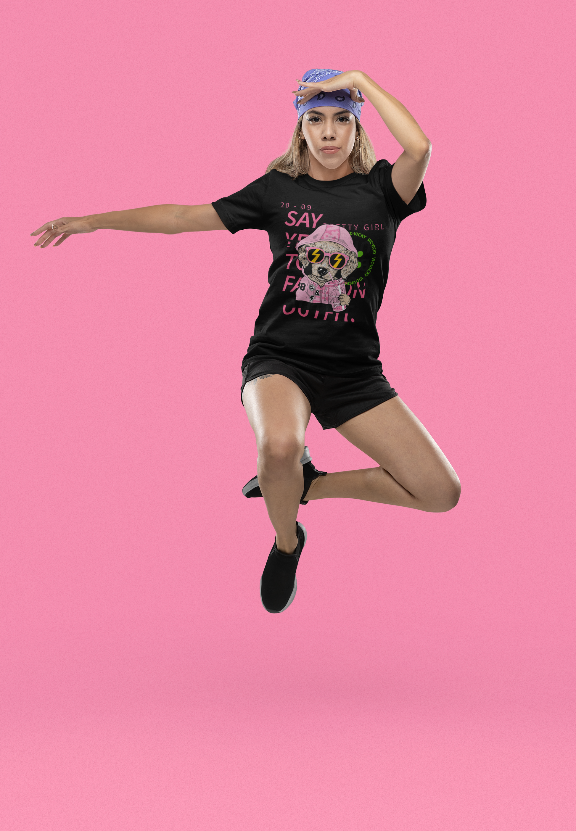A women is jumping and dancing wearing a  tee that encourages embracing personal style with the affirmative statement 'Say Yes to Fashion.