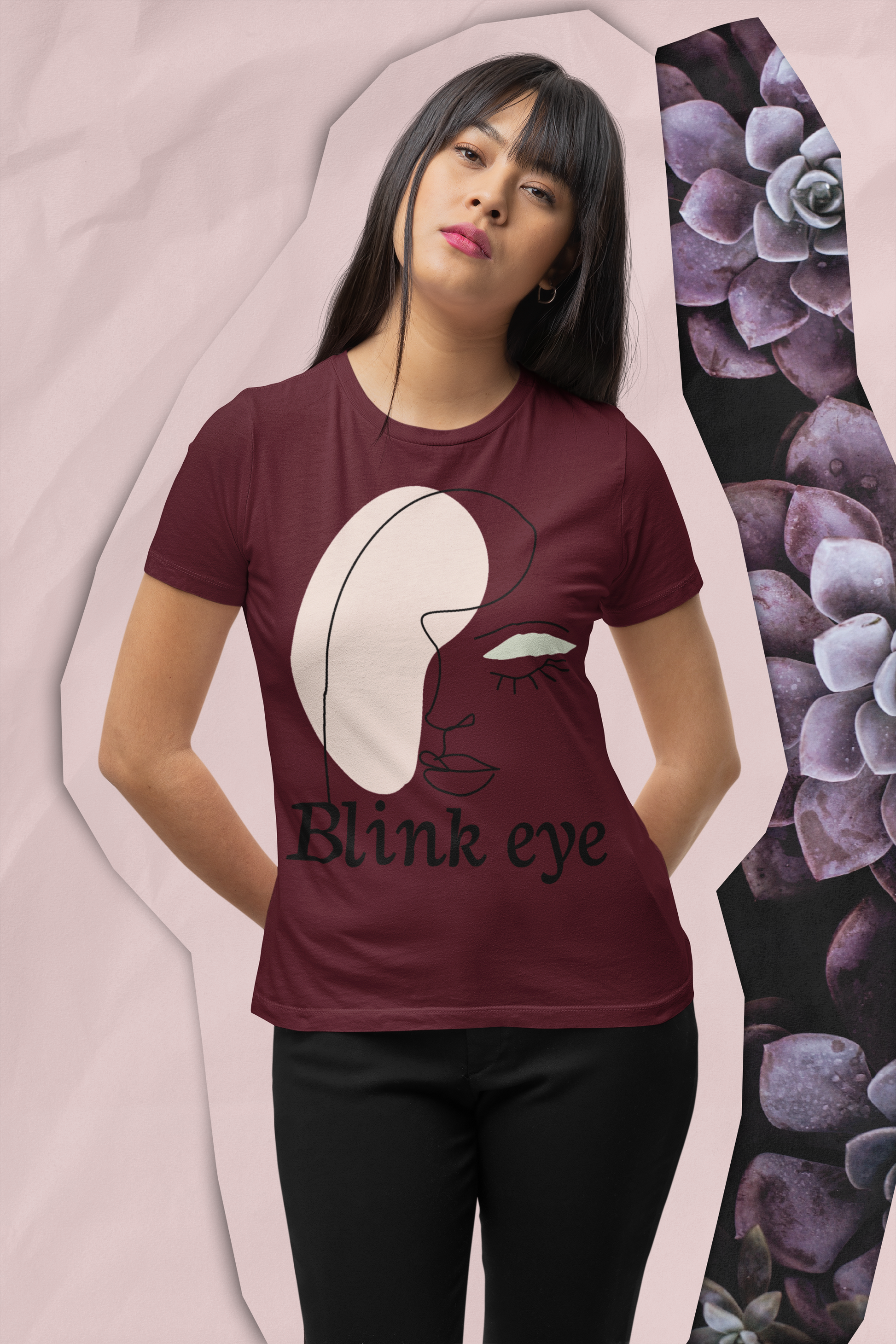 A girl is wearing maroon blinked eye graphic crew neck t-shirt with black bottom