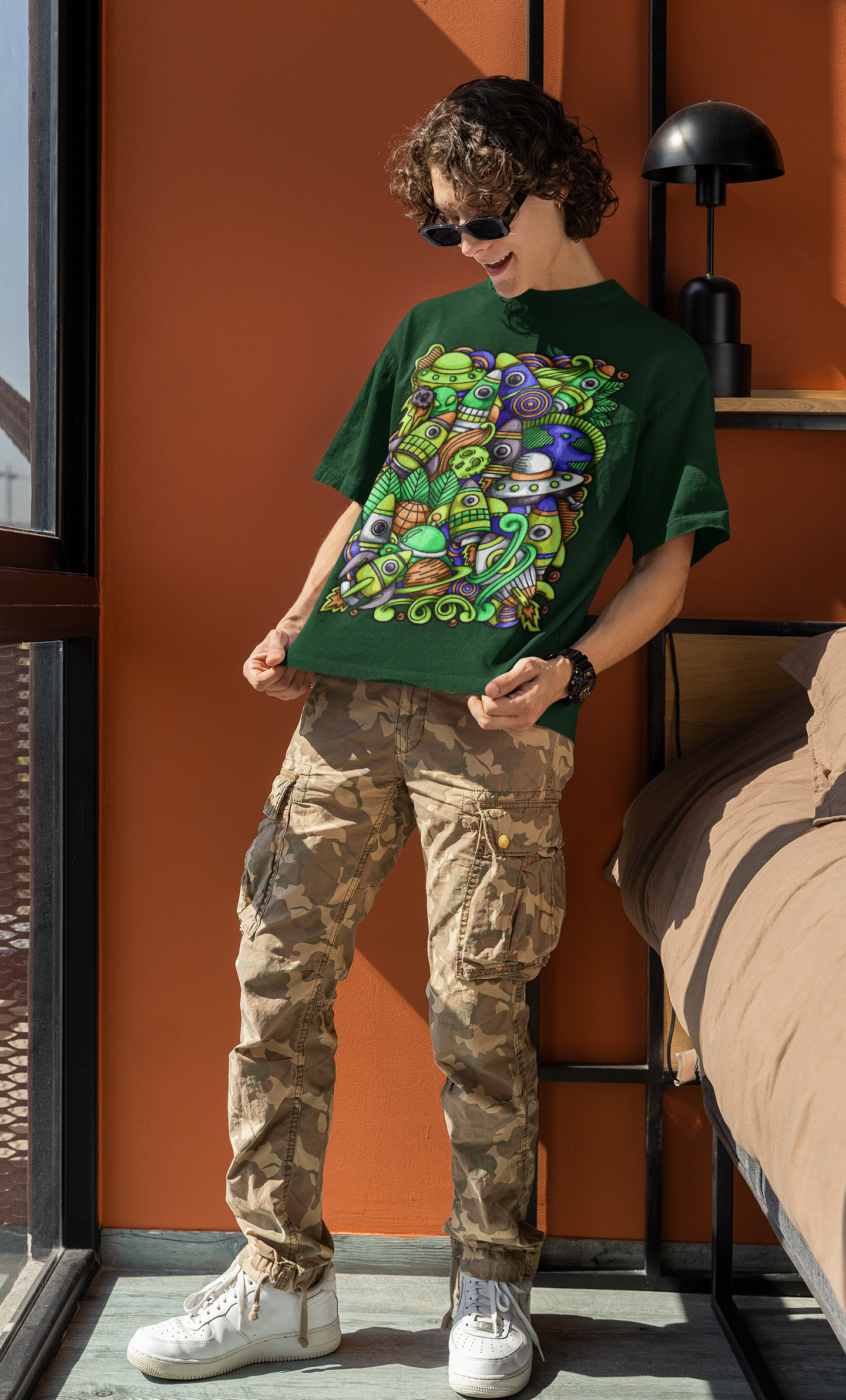 Colorful alien rocket printed on green t-shirt.