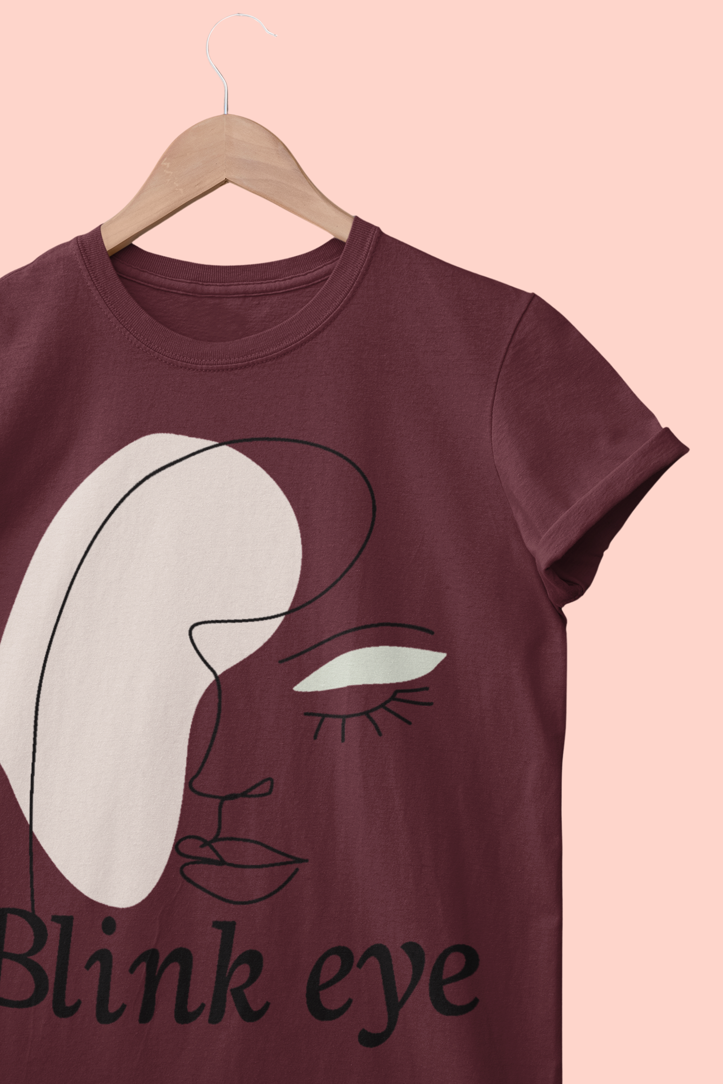 A maroon women shirt with blinked eye graphic print.