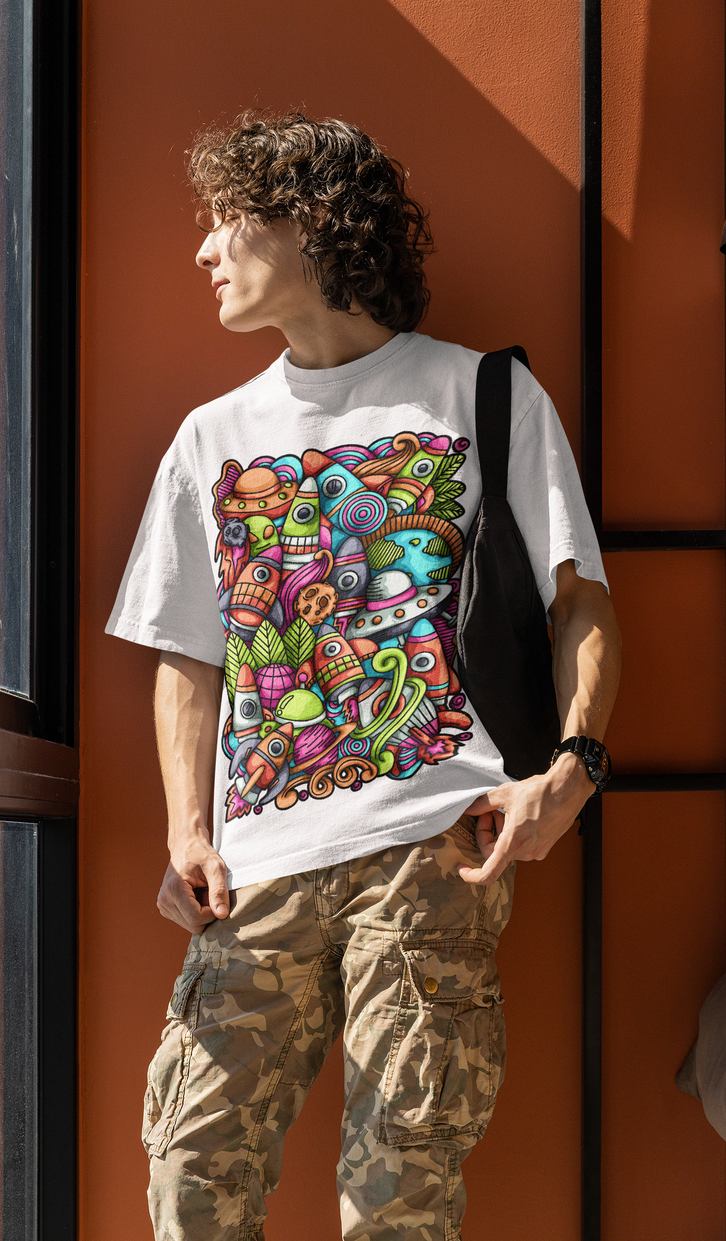 Colorful alien rocket printed on white t-shirt.